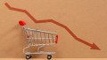 Empty grocery cart with the indicator of a falling economy. Concept of the economic crisis. Inflation. Food shortages, logistics problems.